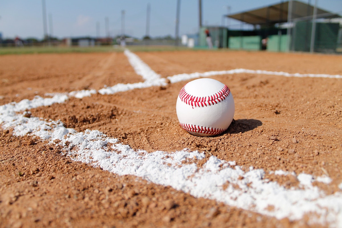 Free baseball on clay field close up image, public domain sport CC0 photo.